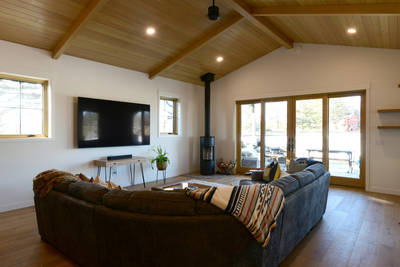 Family room with huge sliders & corner woodburner stove
