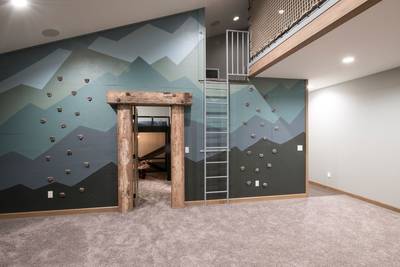 Timber casing in climbing wall to Loft
