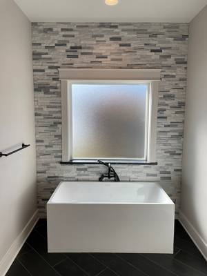 Alcove tub with Tiled window wall
